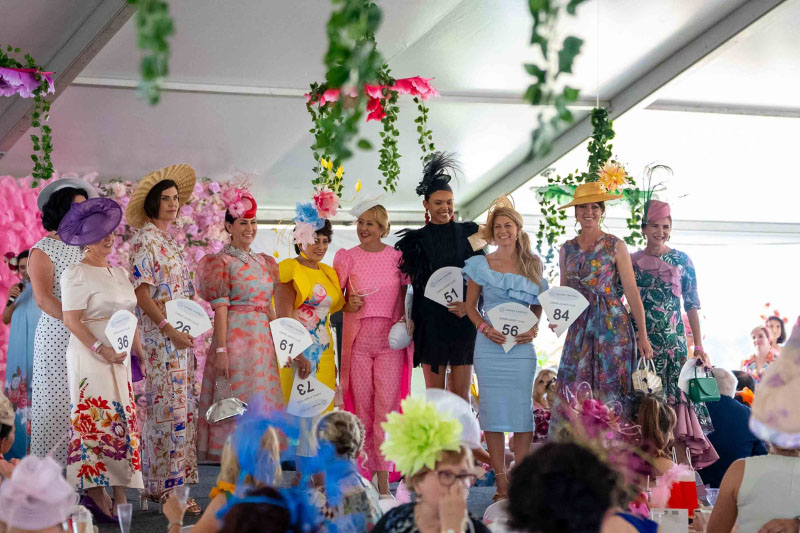 Ladies Long Lunch 2026 – Guests in Race Day Fashion Three guests wearing elegant floral race day outfits and fascinators at the Ladies Long Lunch 2026 event at Cairns Jockey Club.